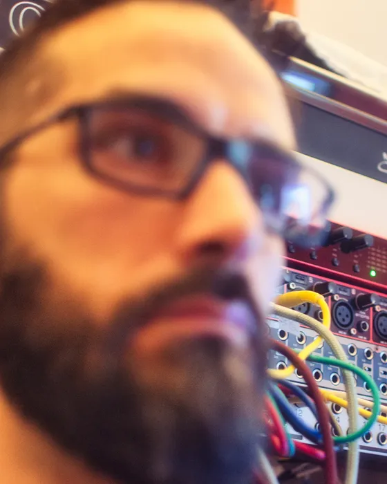 Carmelo Scozzola in the studio, patch bay behind him